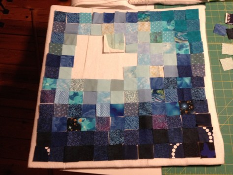 After cutting all the 1.5" squares, the next task was to lay it all out and find a pleasing gradient.