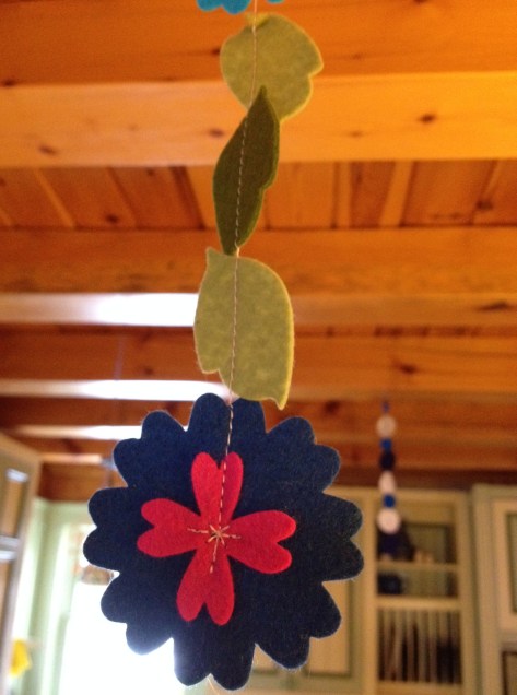 Up with the new (springy flower garland) and down with the old (blue and white snowflake garland).