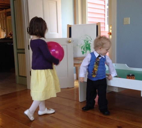 Blurry sweatered kids playing before Easter brunch.