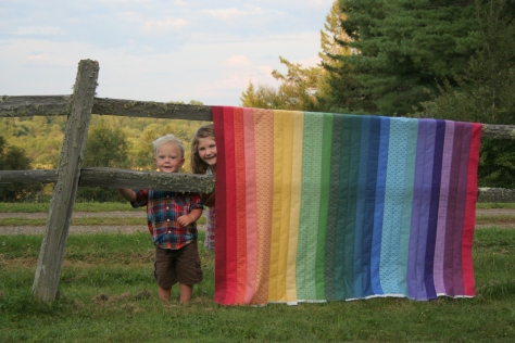 helpful kids and a rainbow jellyroll quilt