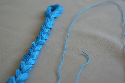 Single thread removed from embroidery floss braid