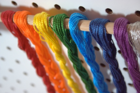 rainbow floss braids on wooden dowel