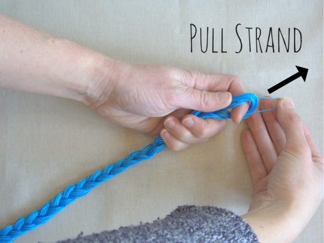 Pull strand of embroidery floss out of braid