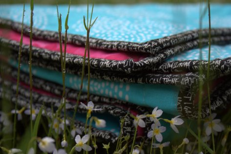 folded quilt in the rainy grass