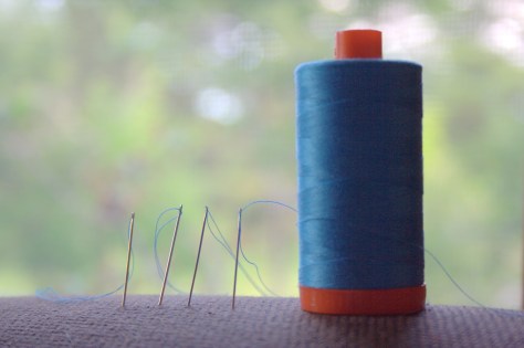 pre threaded and knotted needles in the couch arm