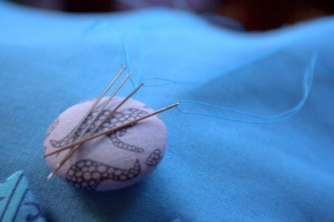 pre threaded and knotted needles on a needle minder