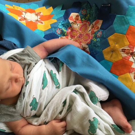 hand stitching with napping baby in lap