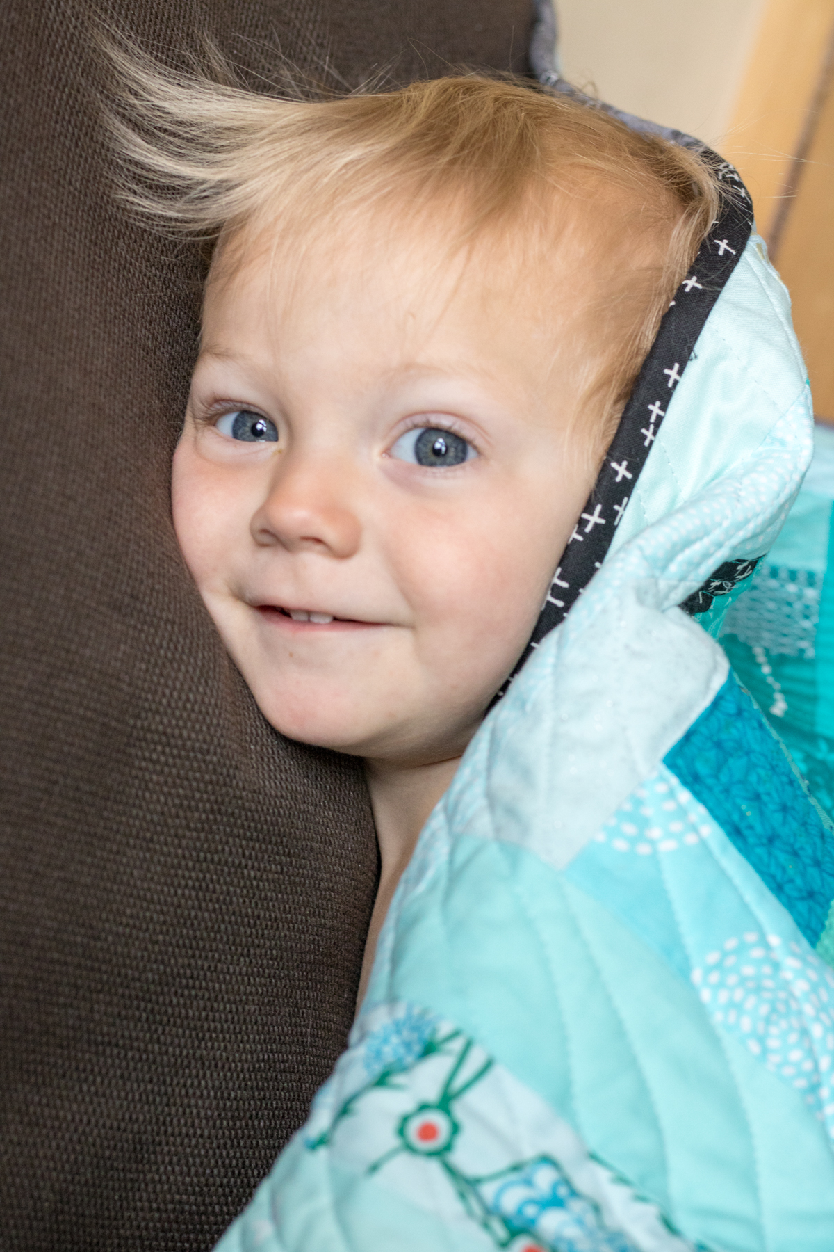 Finn snuggled in his finished milestone quilt