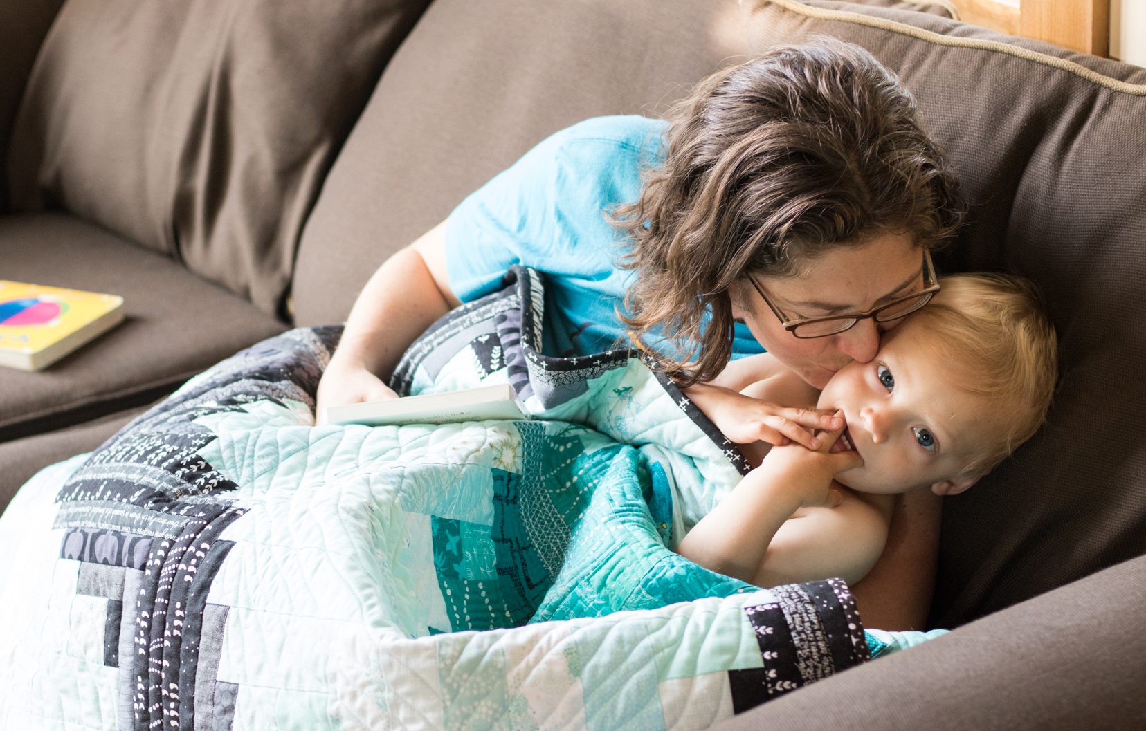 snuggling with Finn under his finished quilt