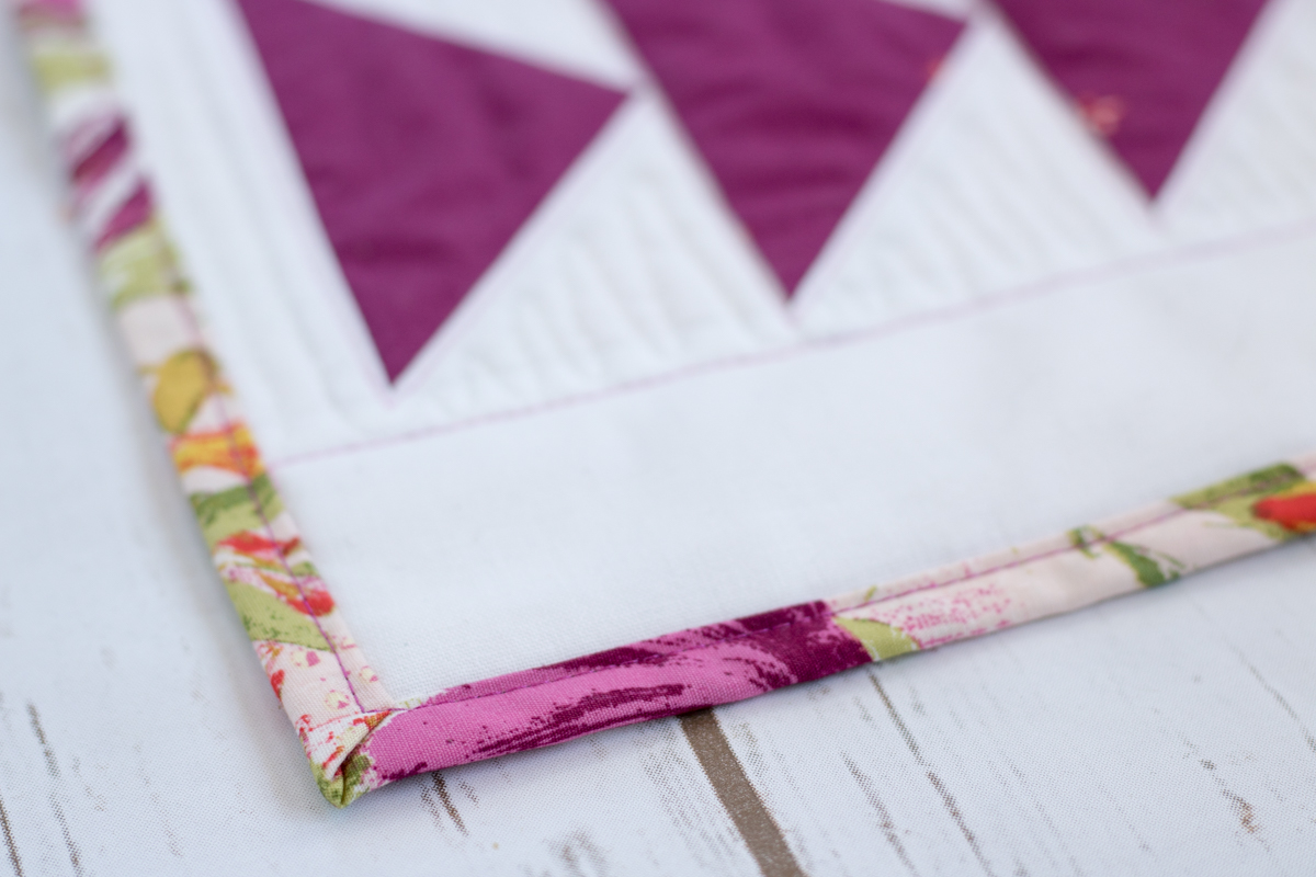 binding close up flying geese table runner